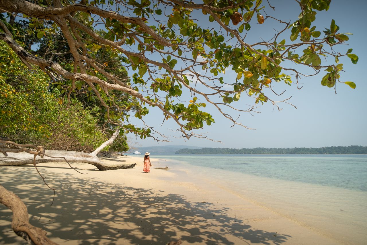 Home Woman enjoying a serene day at Jolly Buoy Island beach, Andaman and Nicobar, India.